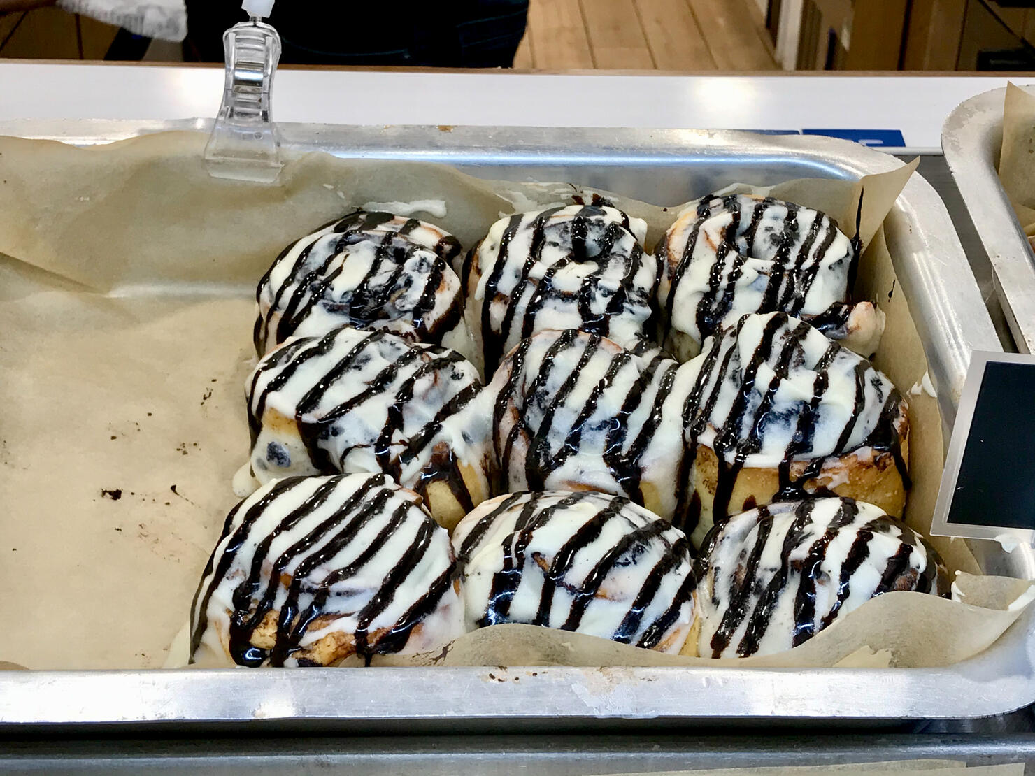 Cinnamon Buns in Glaze for Sale at Showcase of Dessert Shop / Cinnabon in Tray.