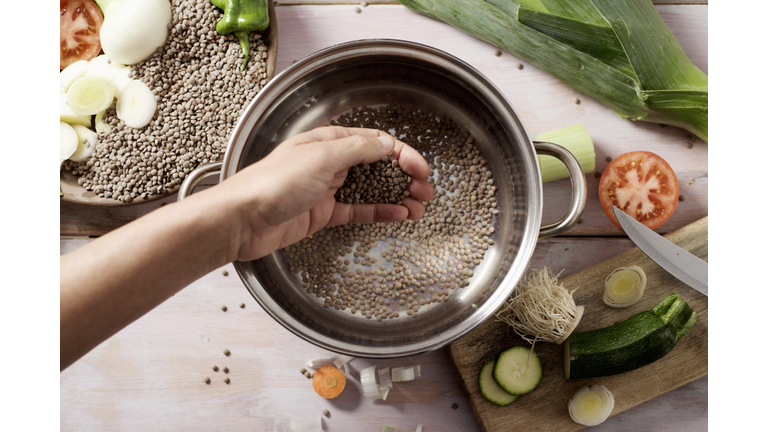 man preparing a vegetarian lentil stew