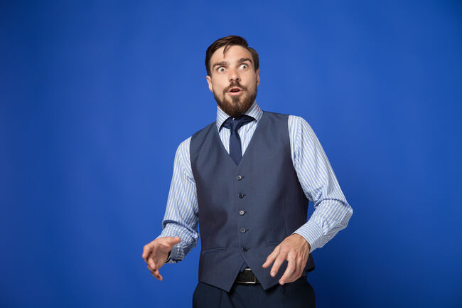 Man looking terrified on blue background