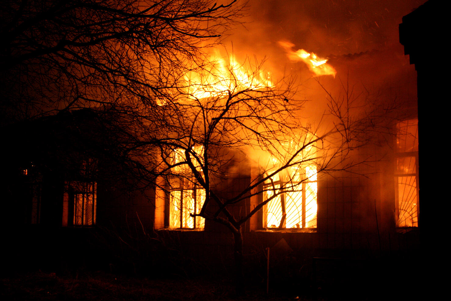 Old building being destroyed by full flaming inferno