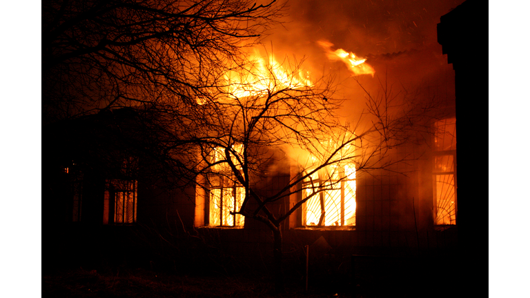 Old building being destroyed by full flaming inferno