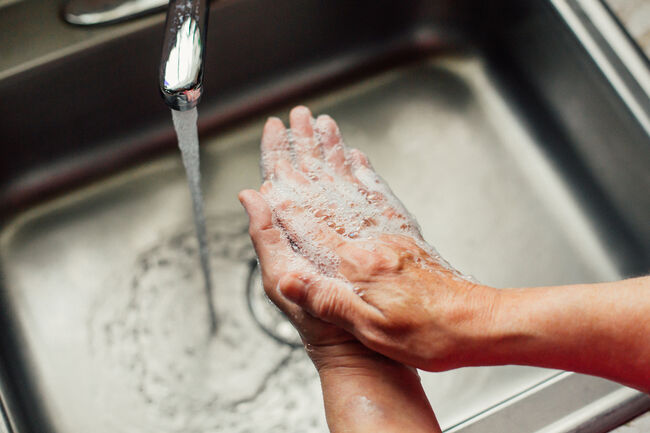 Closeup Woman Washing Hands In Kitchen Sink