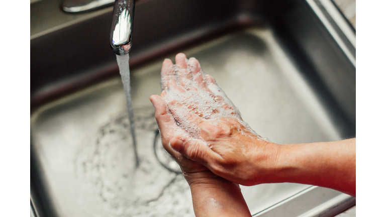 Closeup Woman Washing Hands In Kitchen Sink