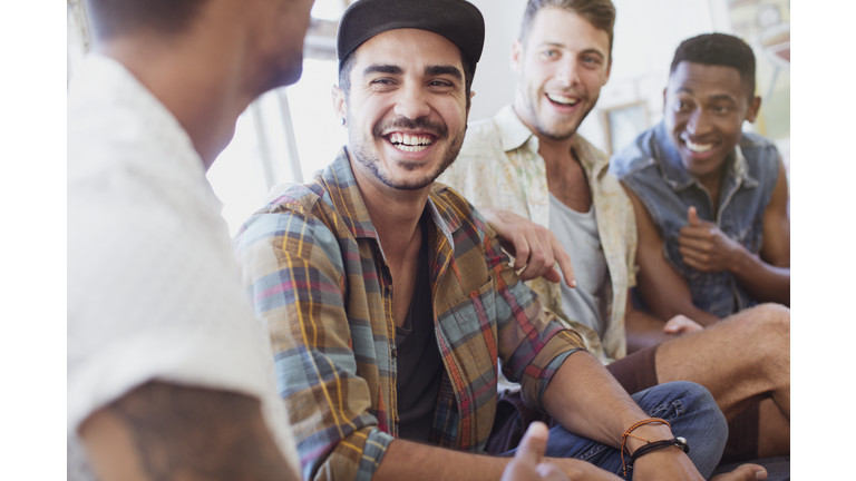 Friends laughing and relaxing indoors