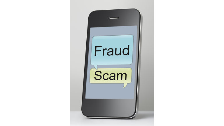 Mobile phone with scam and fraud message speech bubble