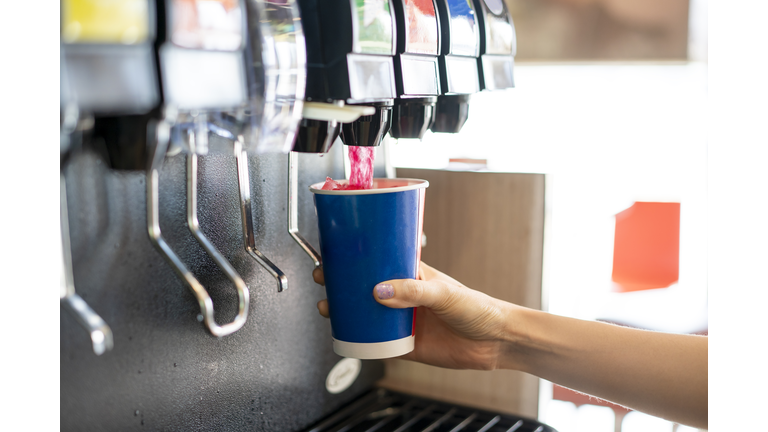 Man pours a fizzy drink.sparkling water.cool ice soft drink cola