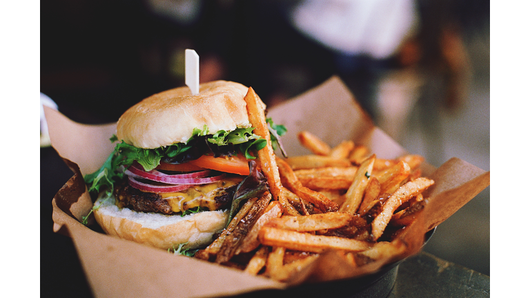 Close-Up Of Burger With French Fries On Table