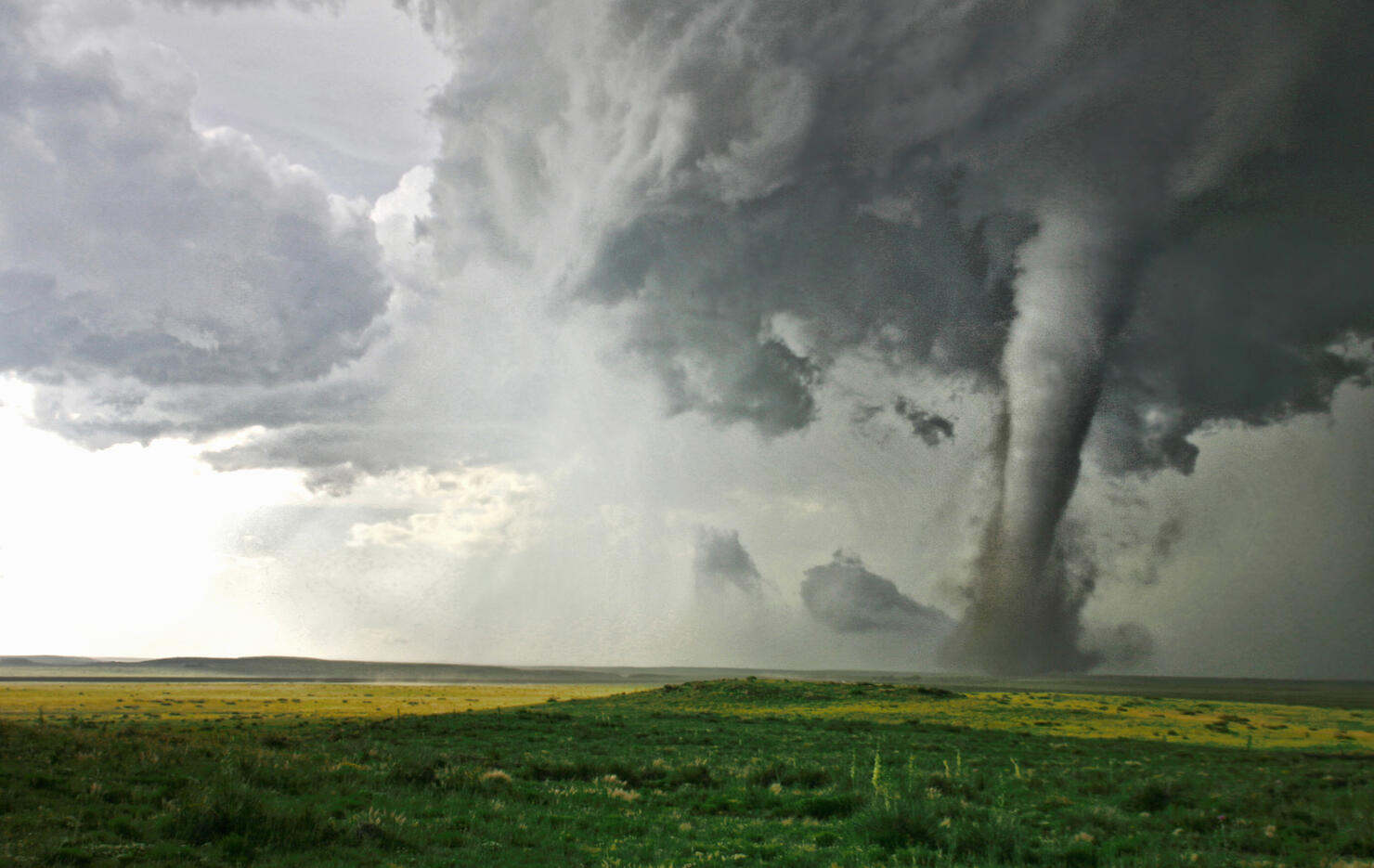 Tornado column in rural landscape