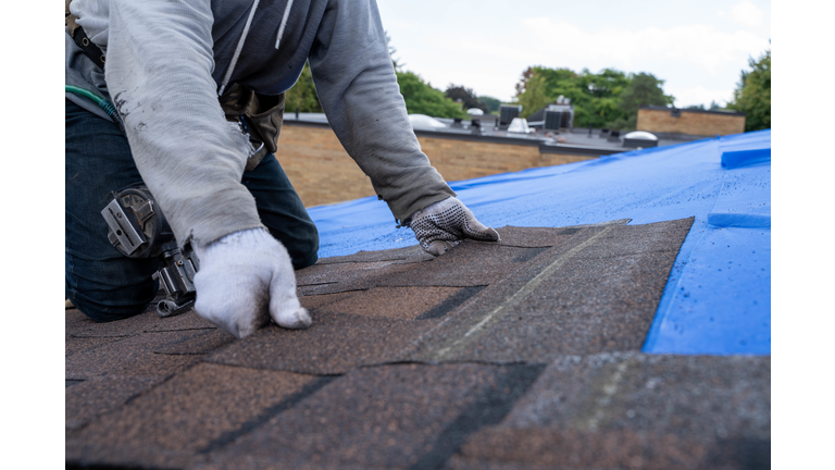 Roofers installing new roof on house