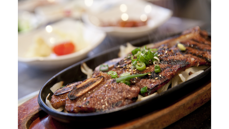 A close-up of Korean BBQ short ribs in a black dish