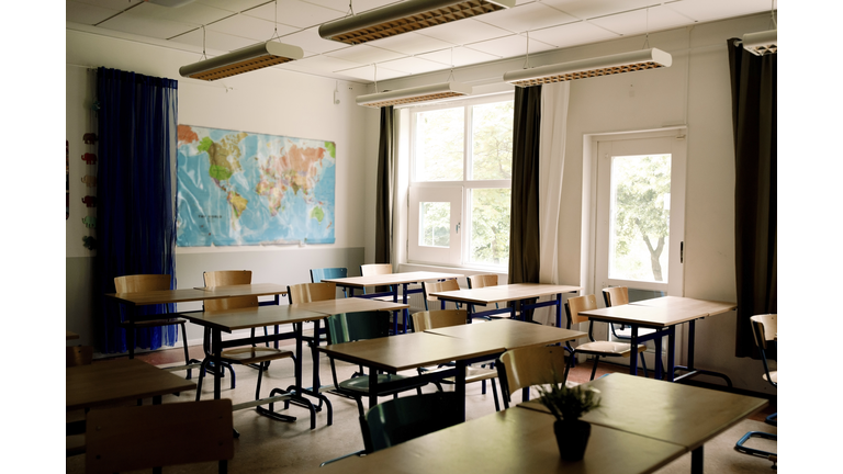 Desks and chairs arranged in classroom at high school