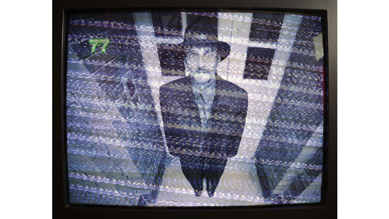 man on security monitor