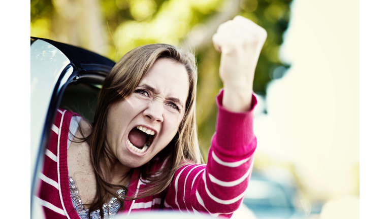 Women drivers get road rage too! Furious female shaking fist