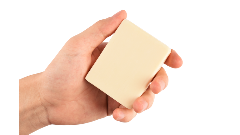 Man hand holding a natural soap bar (Clipping path) on the white background