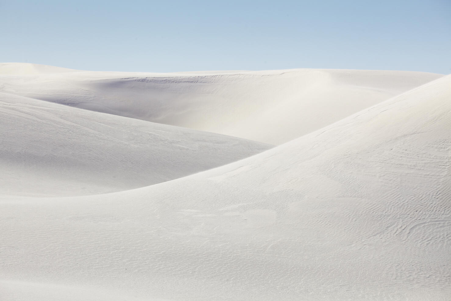 Rolling white sand dunes on a sunny day at White Sands National Park, New Mexico, United States