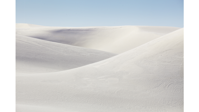 Rolling white sand dunes on a sunny day at White Sands National Park, New Mexico, United States