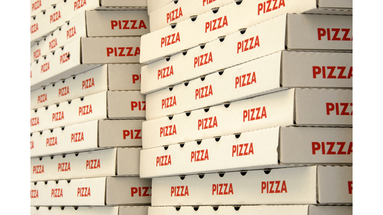 Two stacks of red and white pizza boxes