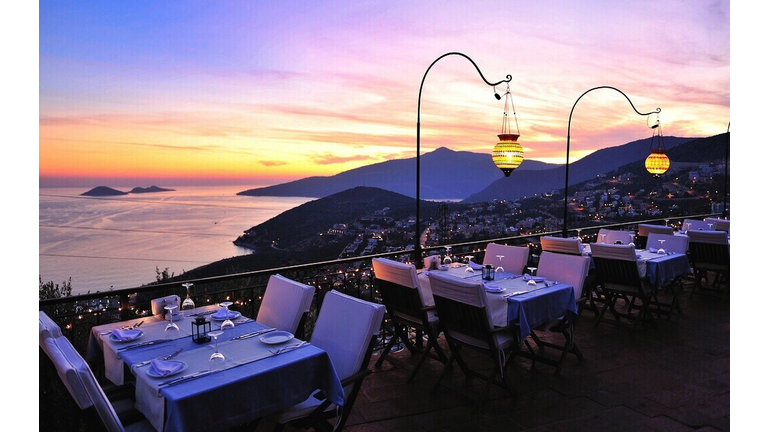 Dinning Table At Sidewalk Cafe By Mountains And Sea During Sunset