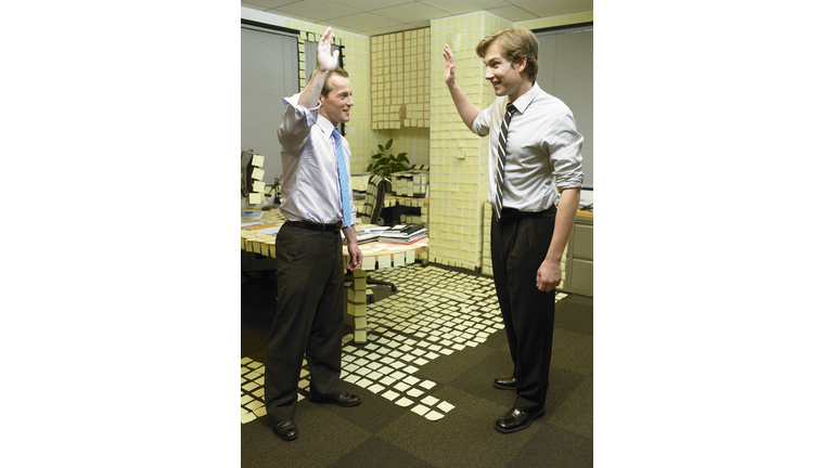 Two office workers having high-five