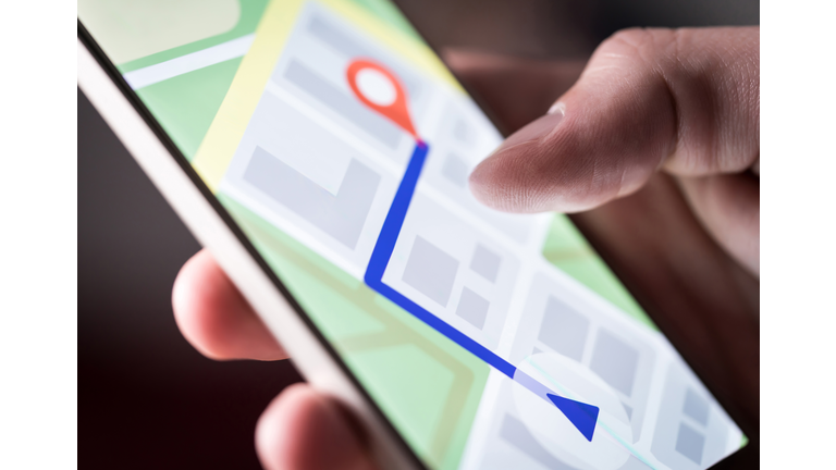 Map application in smartphone. Man navigating in city with mobile phone. Person using cellphone and searching hotel with navigation app.