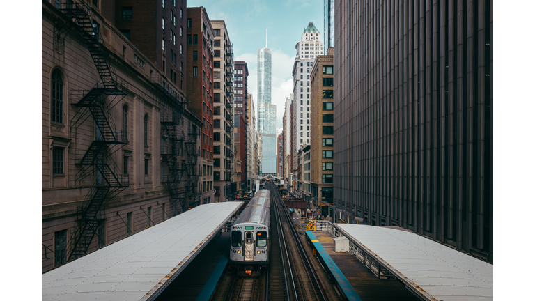 Railroad Station Amidst Buildings In City Against Sky