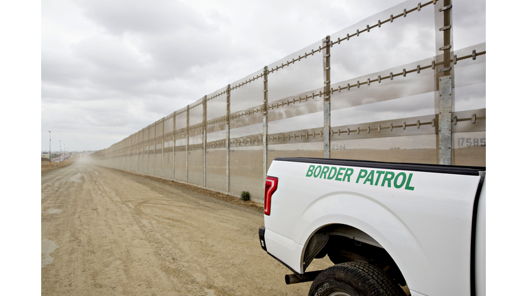 A border fence stands along the U.S.-Mexico border