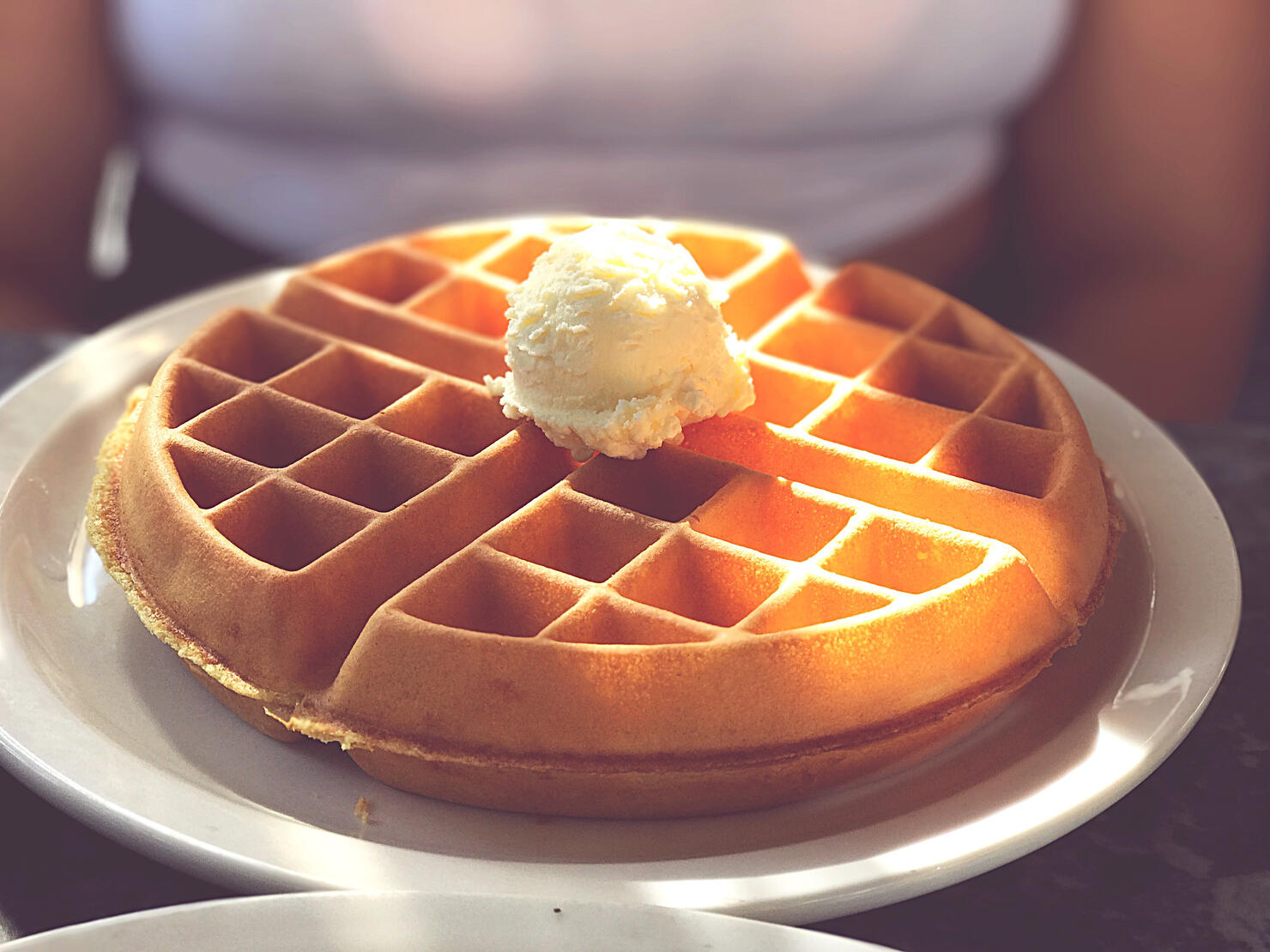 Midsection Of Woman With Ice Cream On Waffle In Plate