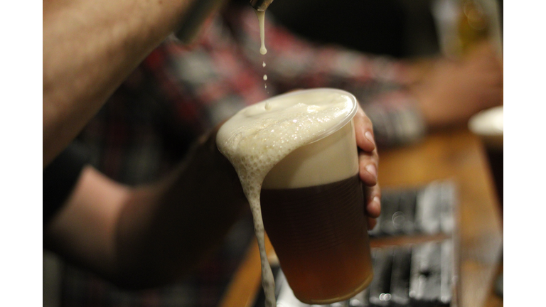 Cropped Hands Of Man Pouring Beer In Glass