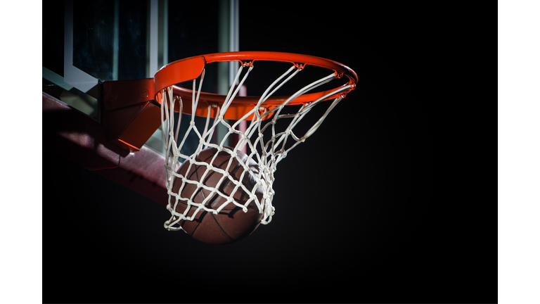 Ball falling through a Basketball Hoop