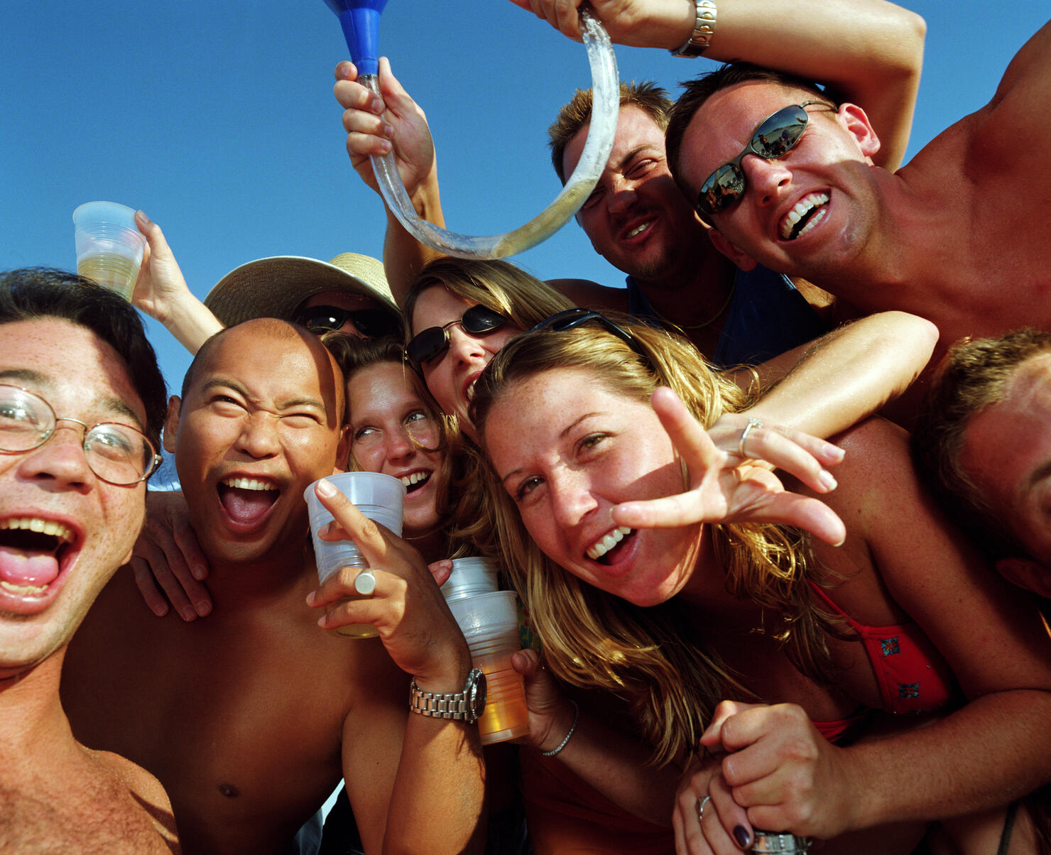 Group of young people wearing swimsuits, drinking beer, portrait