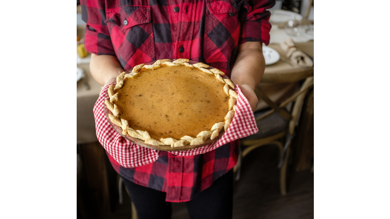 USA, New York State, New York City, Woman holding baked pumpkin pie for Thanksgiving