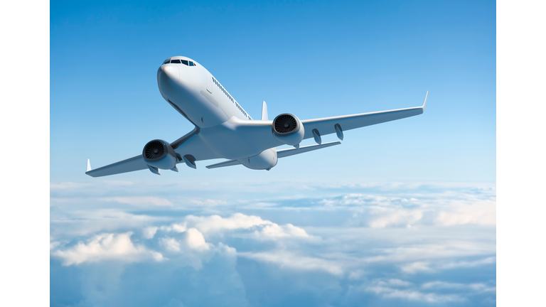 Passenger jet airplane flying above clouds