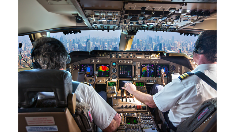 Cockpit of a modern passenger aircraft. Pilots at work.