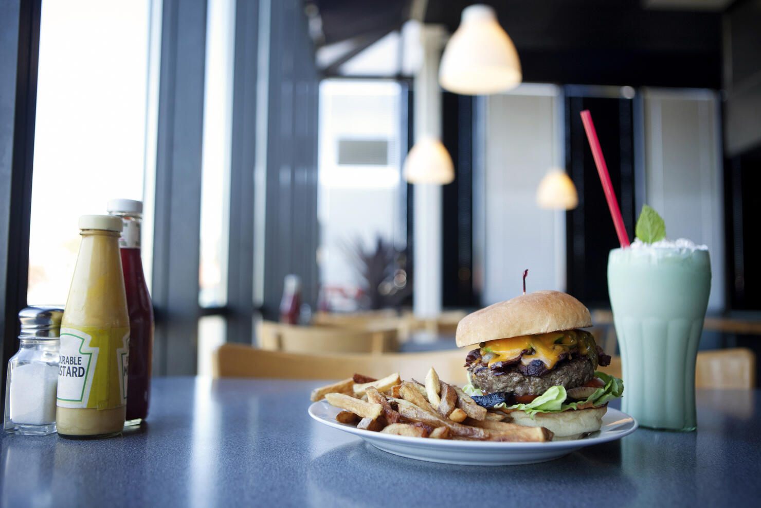 Cheeseburger, french fries and milkshake in diner