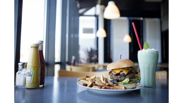 Cheeseburger, french fries and milkshake in diner