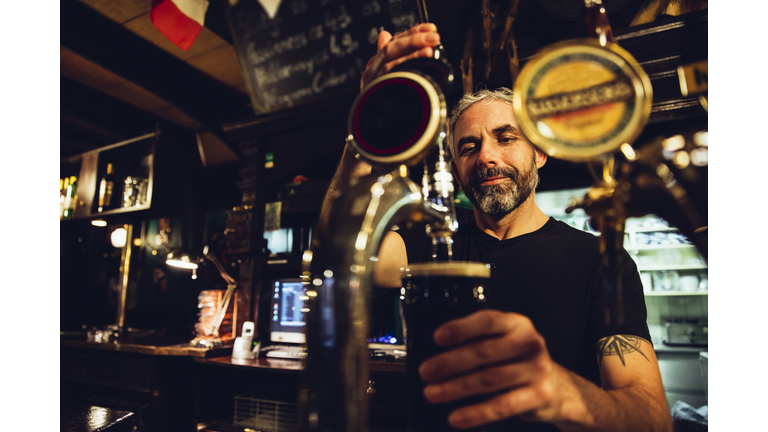 Man tapping beer in an Irish pub