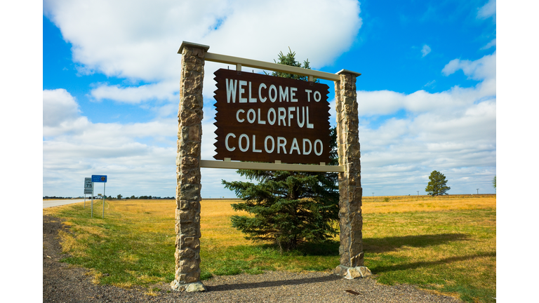 Welcome sign for Colorful Colorado on a grassy field