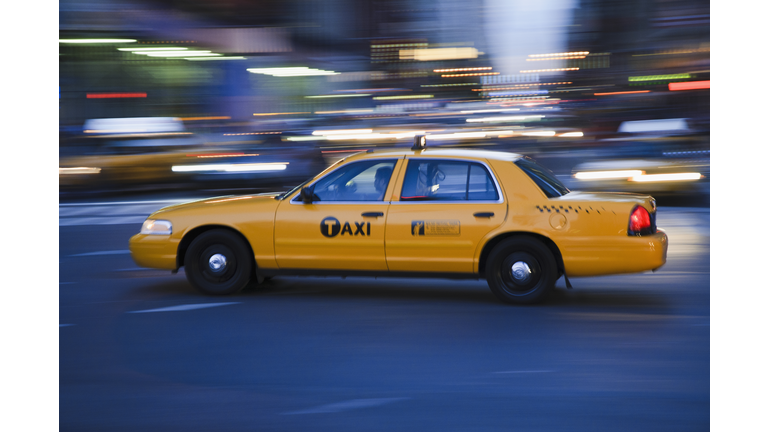 Taxi cab driving in the evening