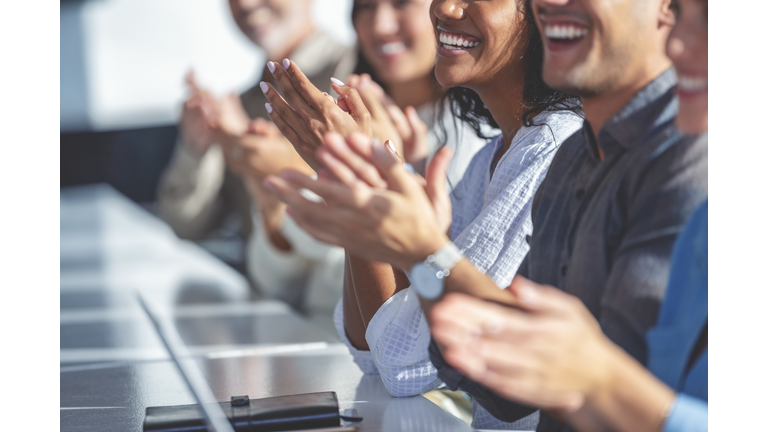 Close up of the hands of a Group of business people applauding a presentation.