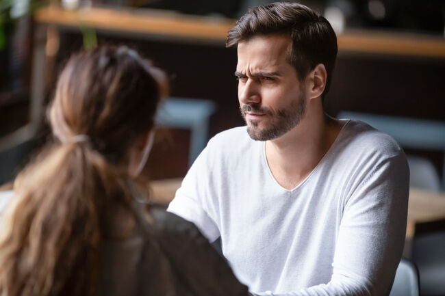 Doubting dissatisfied man looking at woman, bad first date concept