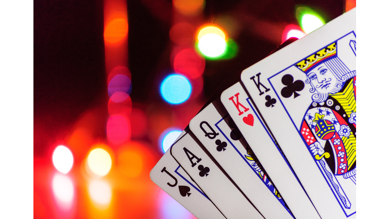 Close-Up Of Playing Cards Against Illuminated Lights