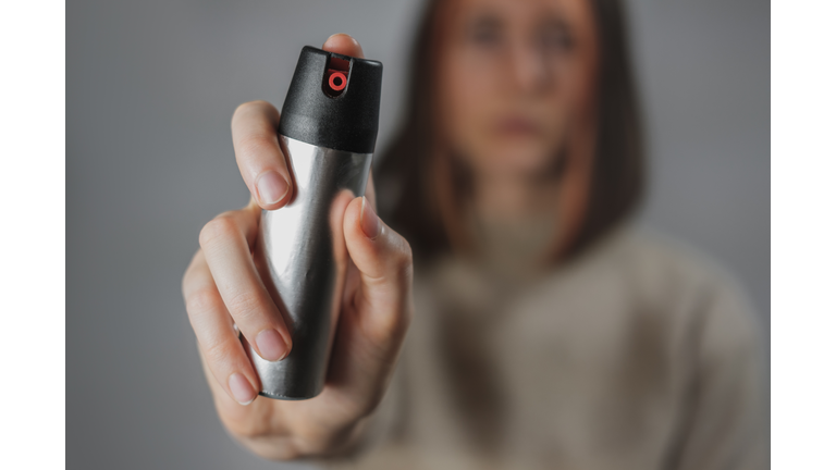 Woman with a pepper spray, close-up view