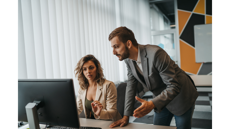 Male and female Office employees having argument at workplace