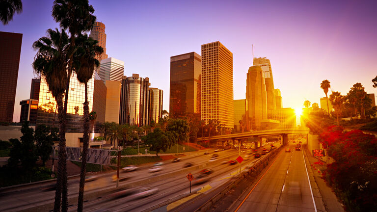 Sunset. Traffic. Modern Los Angeles Business District.