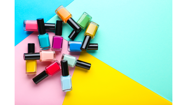 Nail polish bottles on colorful background