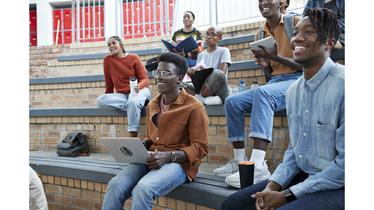 Smiling multi-ethnic students enjoying at campus