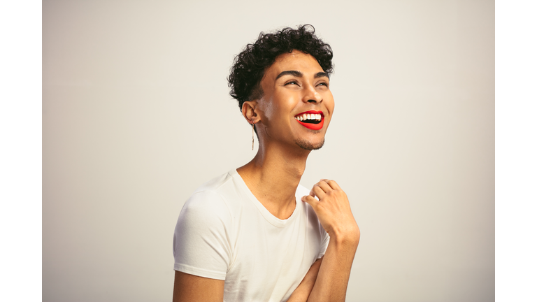 Transgender man with makeup laughing