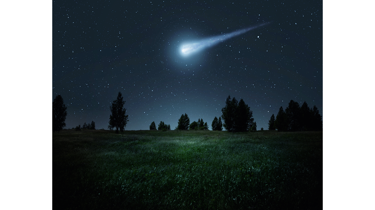 Night scene with a comet, asteroid, meteorite flying to Earth. Night landscape. Elements of this image furnished by NASA.