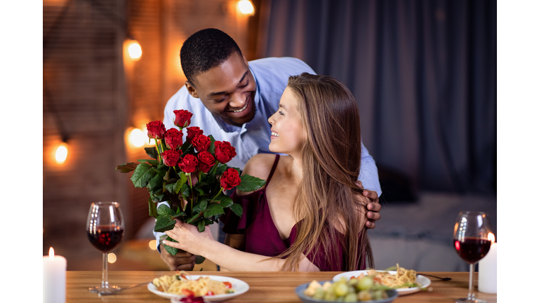 Loving African American Guy Surprising His Beautiful Girlfriend With Roses Bouquet