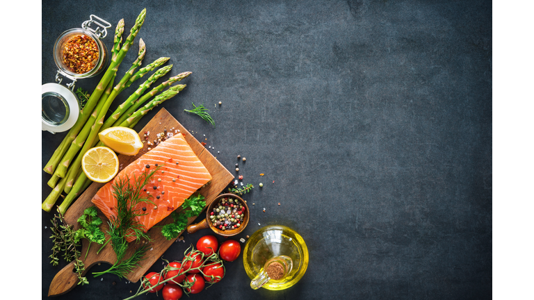 Fresh salmon fillet with aromatic herbs, spices and vegetables